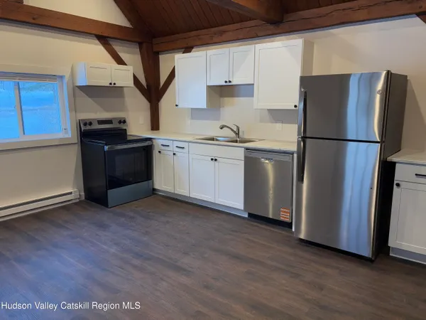 a kitchen with a refrigerator sink and cabinets