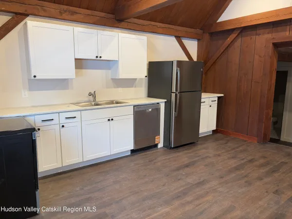 a kitchen with stainless steel appliances a refrigerator sink and cabinets