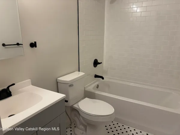 a bathroom with a sink a toilet and bathtub