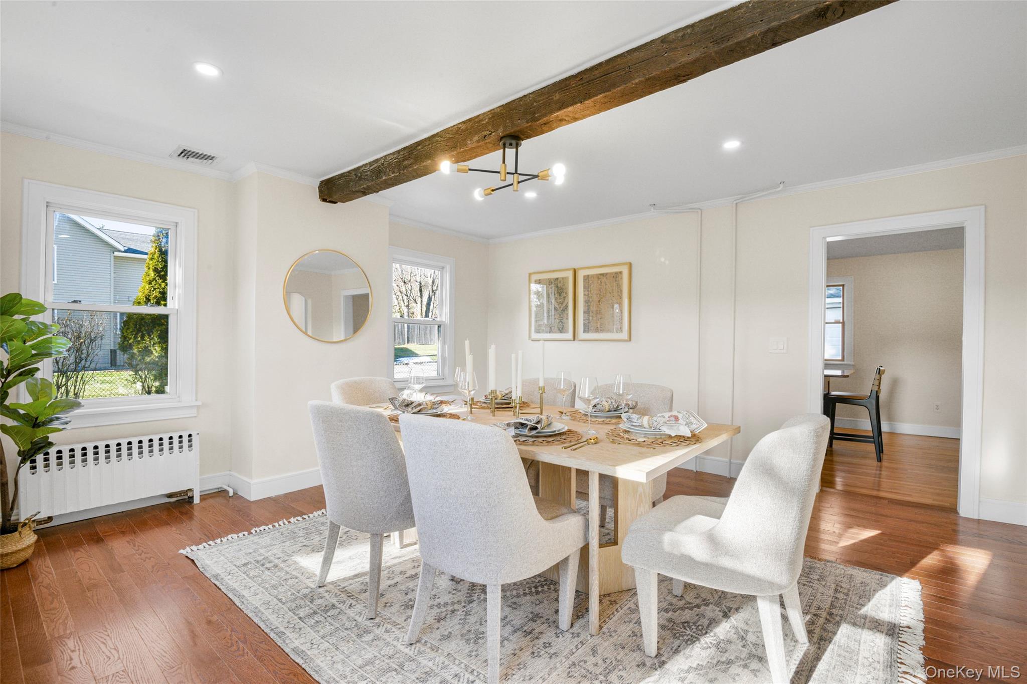 103 Old White Plains Road Tarrytown, NY 10591 - Photo 11 of 37 a dining room with wooden floor a glass table and chairs