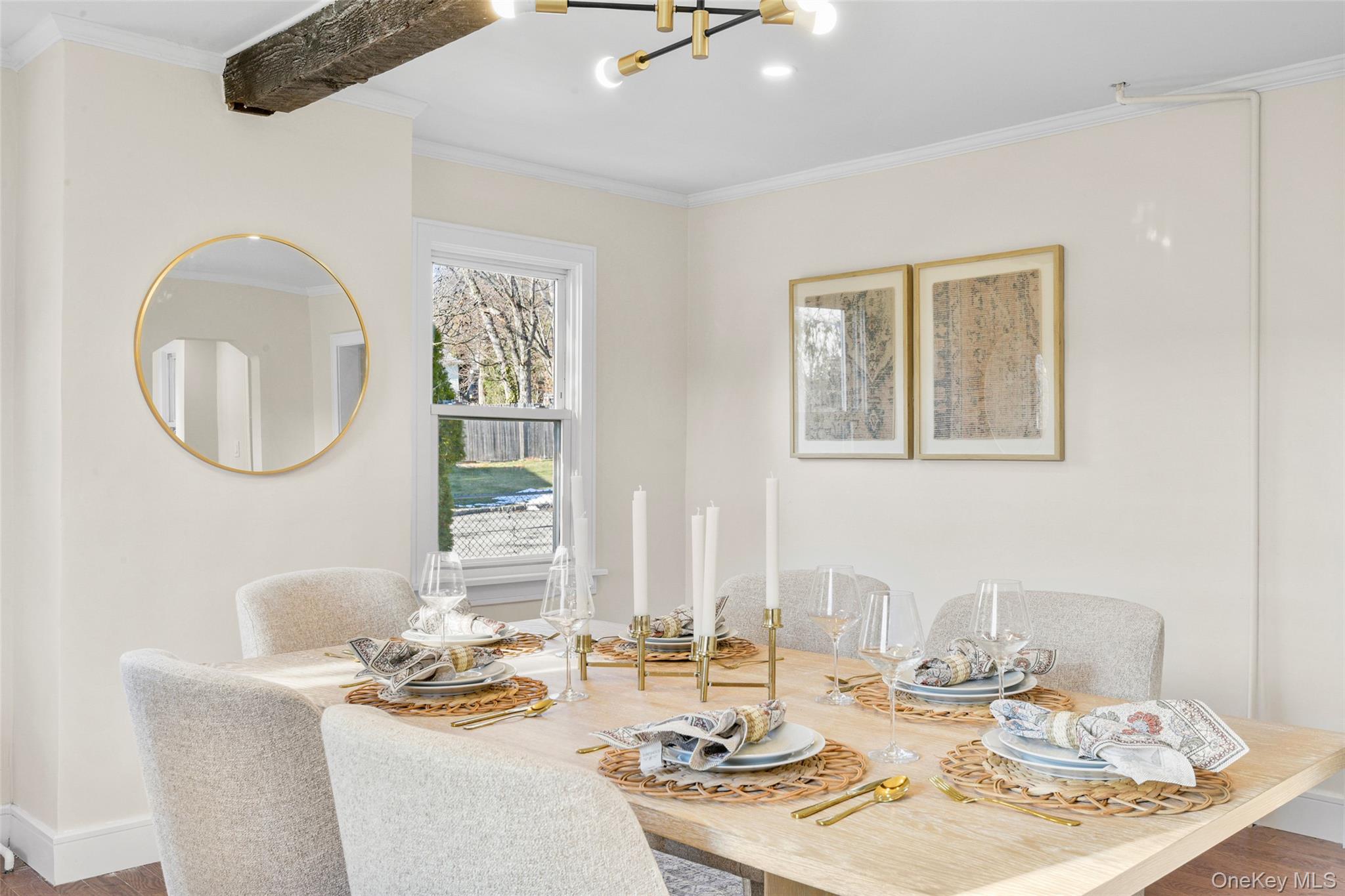 103 Old White Plains Road Tarrytown, NY 10591 - Photo 12 of 37 a dining room with wooden floor a chandelier fan a wooden table and chairs