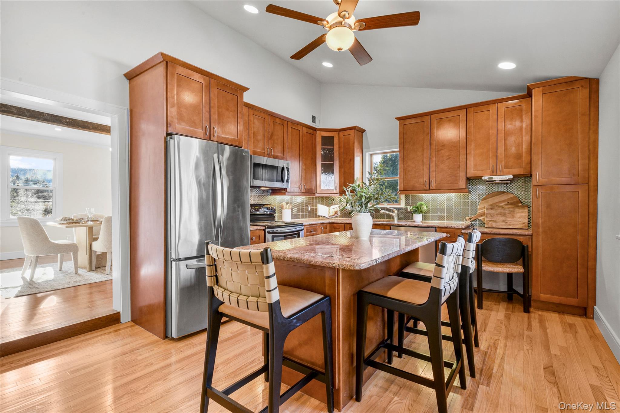 103 Old White Plains Road Tarrytown, NY 10591 - Photo 15 of 37 a dining room with stainless steel appliances a dining table chairs and chandelier