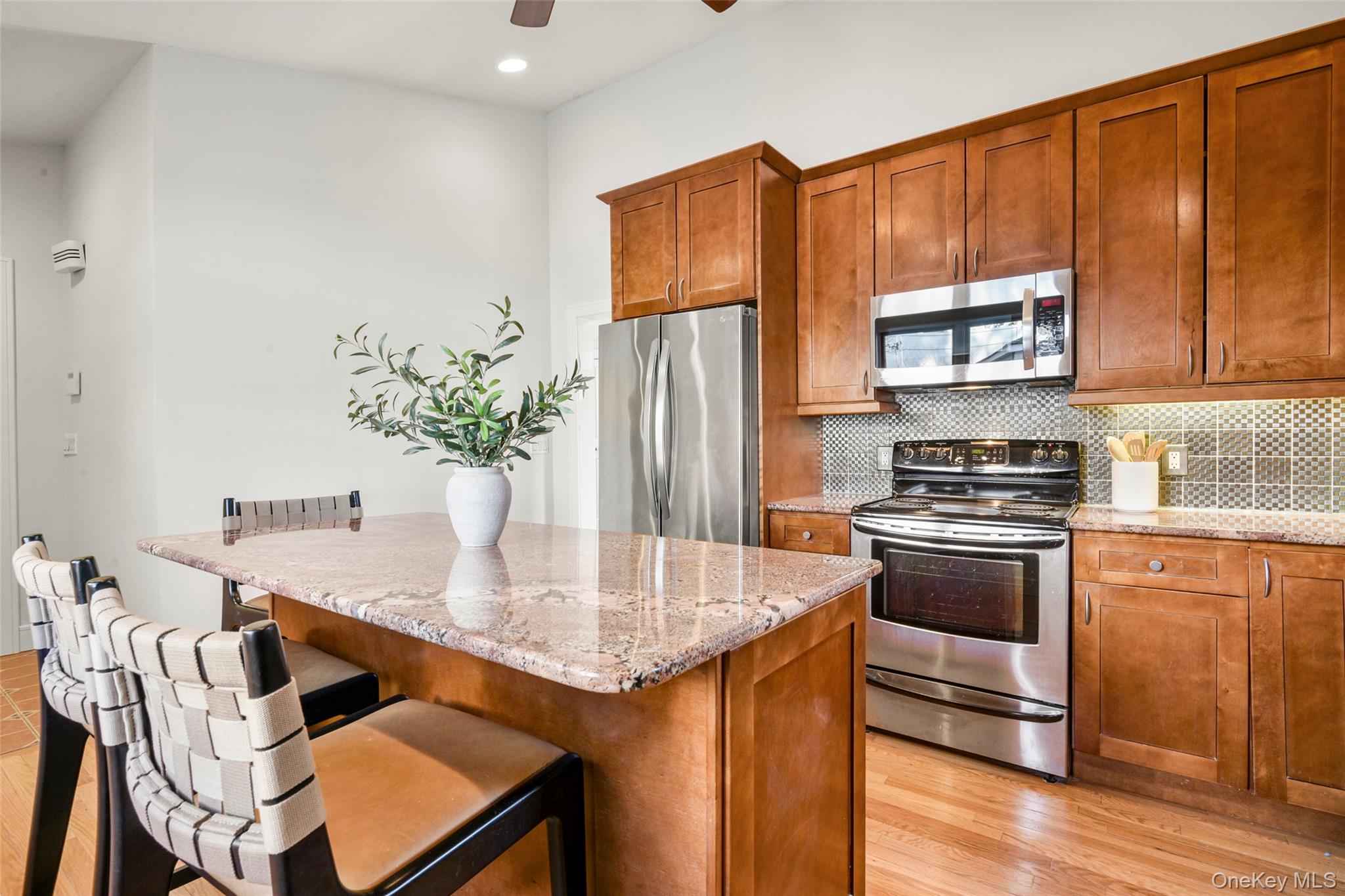 103 Old White Plains Road Tarrytown, NY 10591 - Photo 17 of 37 a kitchen with stainless steel appliances granite countertop a stove refrigerator sink and cabinets