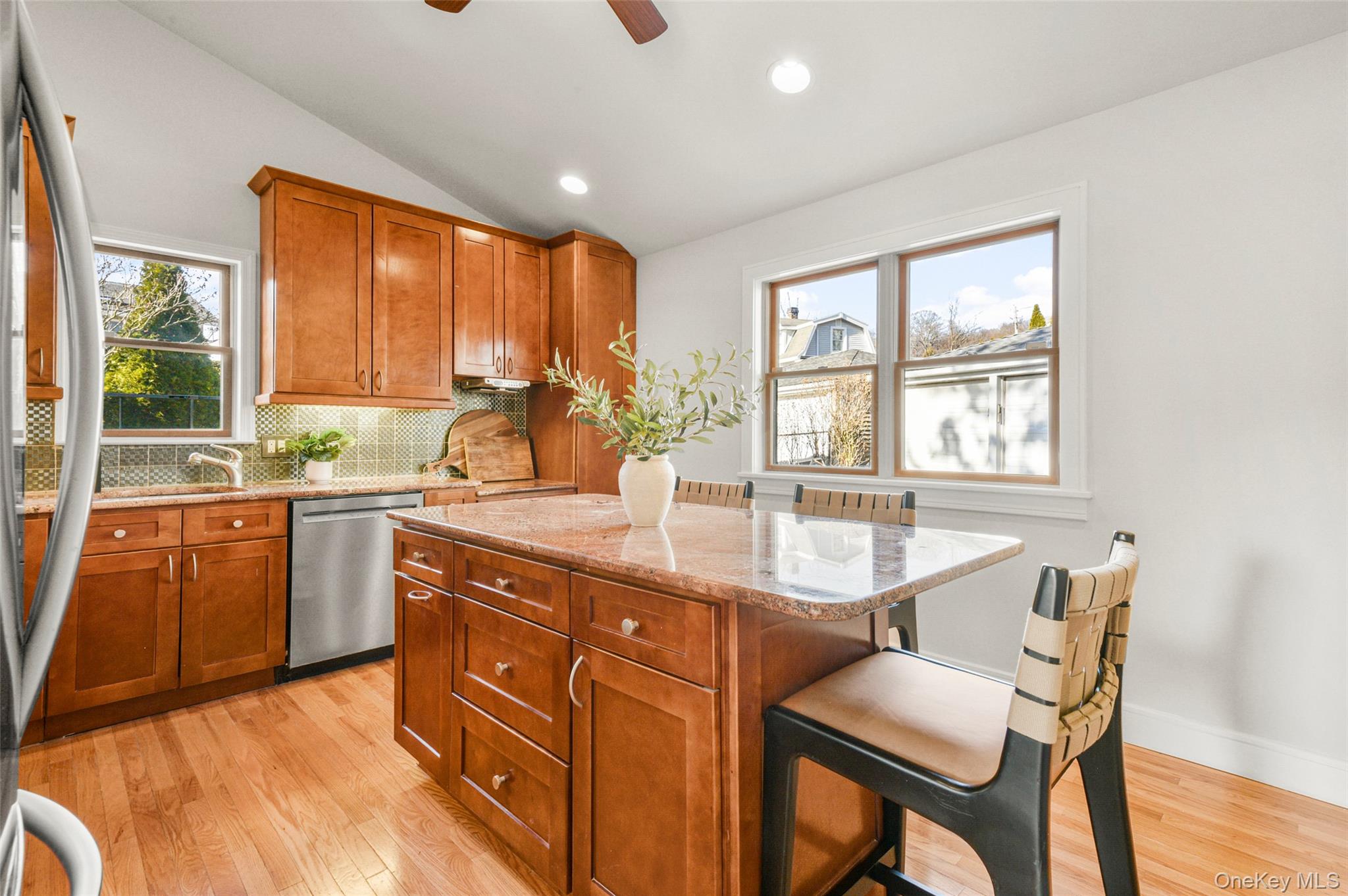 103 Old White Plains Road Tarrytown, NY 10591 - Photo 18 of 37 a kitchen with stainless steel appliances granite countertop sink stove and wooden cabinets