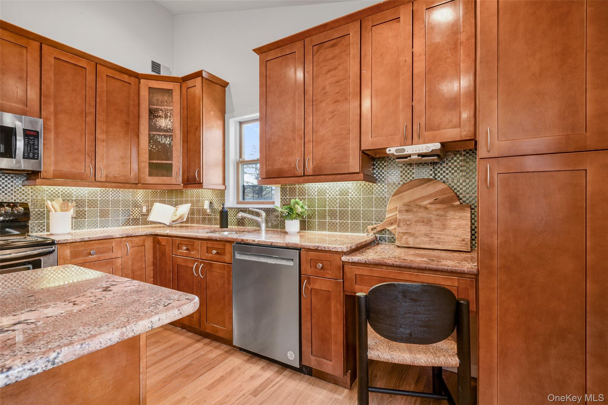 103 Old White Plains Road Tarrytown, NY 10591 - Photo 20 of 37 a kitchen with a sink a stove and cabinets