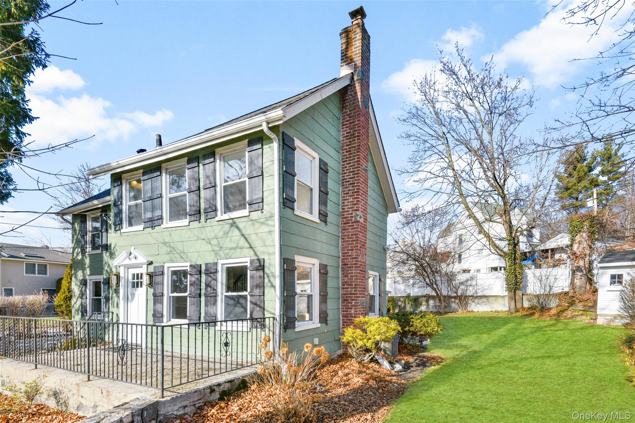 103 Old White Plains Road Tarrytown, NY 10591 - Photo 2 of 37 a front view of a house with garden