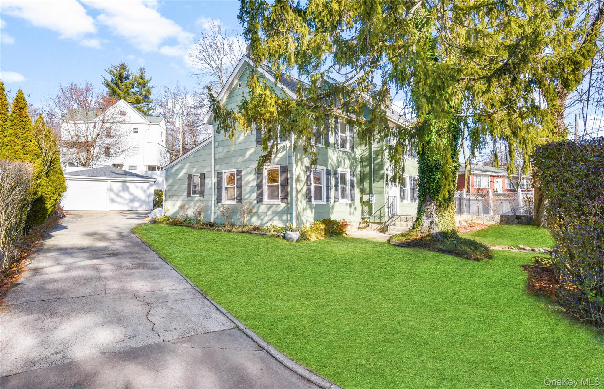 103 Old White Plains Road Tarrytown, NY 10591 - Photo 3 of 37 a view of a yard with plants and large trees