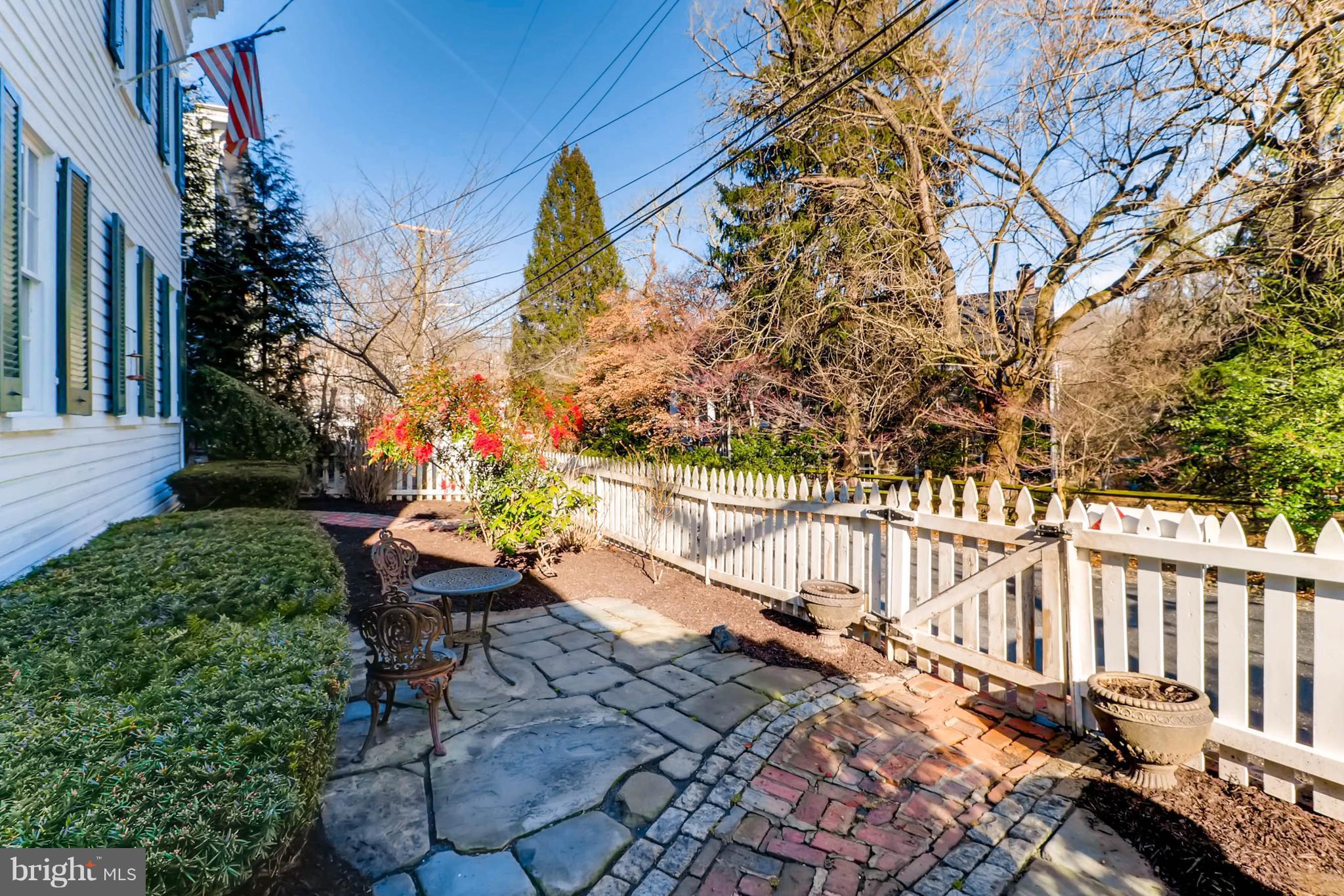 2326 Pickwick Road Baltimore, MD 21207 - Photo 2 of 30 a backyard of a house with table and chairs and wooden fence