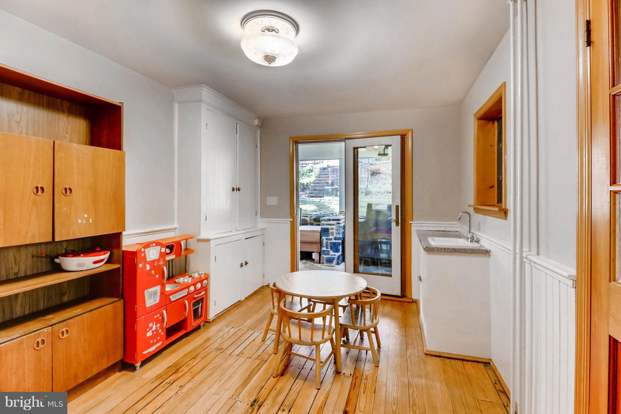 2326 Pickwick Road Baltimore, MD 21207 - Photo 13 of 30 a very nice looking room with wooden floor and furniture