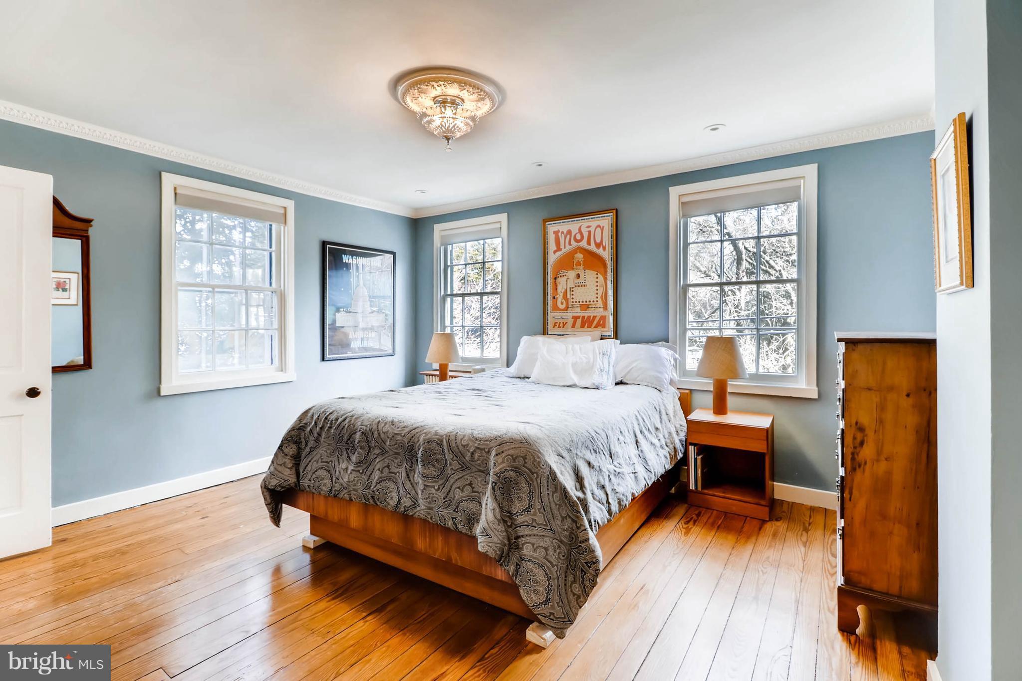 2326 Pickwick Road Baltimore, MD 21207 - Photo 15 of 30 a bedroom with a bed and wooden floor
