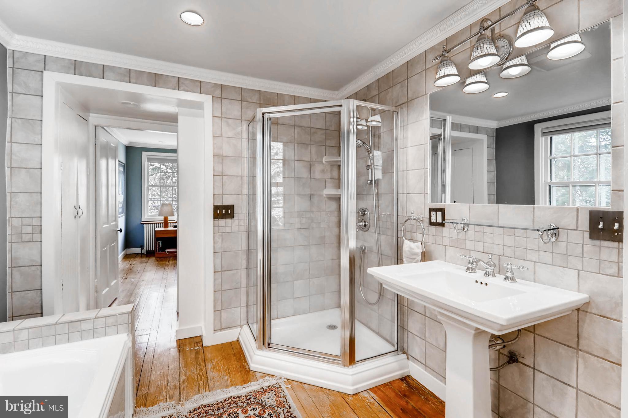 2326 Pickwick Road Baltimore, MD 21207 - Photo 17 of 30 a bathroom with a sink a toilet and shower