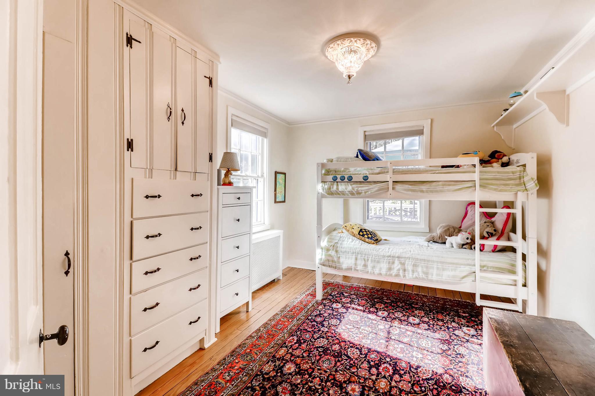 2326 Pickwick Road Baltimore, MD 21207 - Photo 19 of 30 a bedroom with furniture and a chandelier