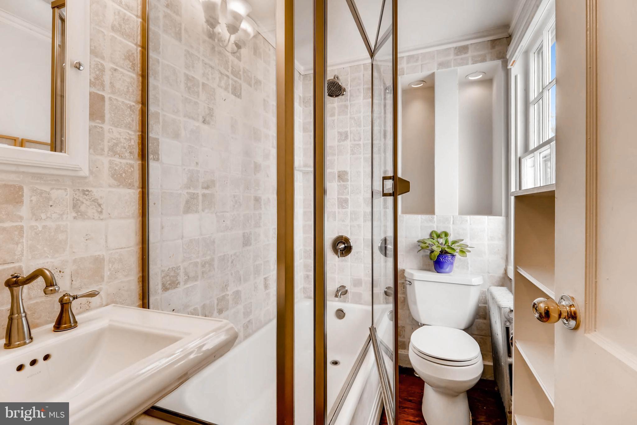2326 Pickwick Road Baltimore, MD 21207 - Photo 21 of 30 a bathroom with a sink toilet and shower