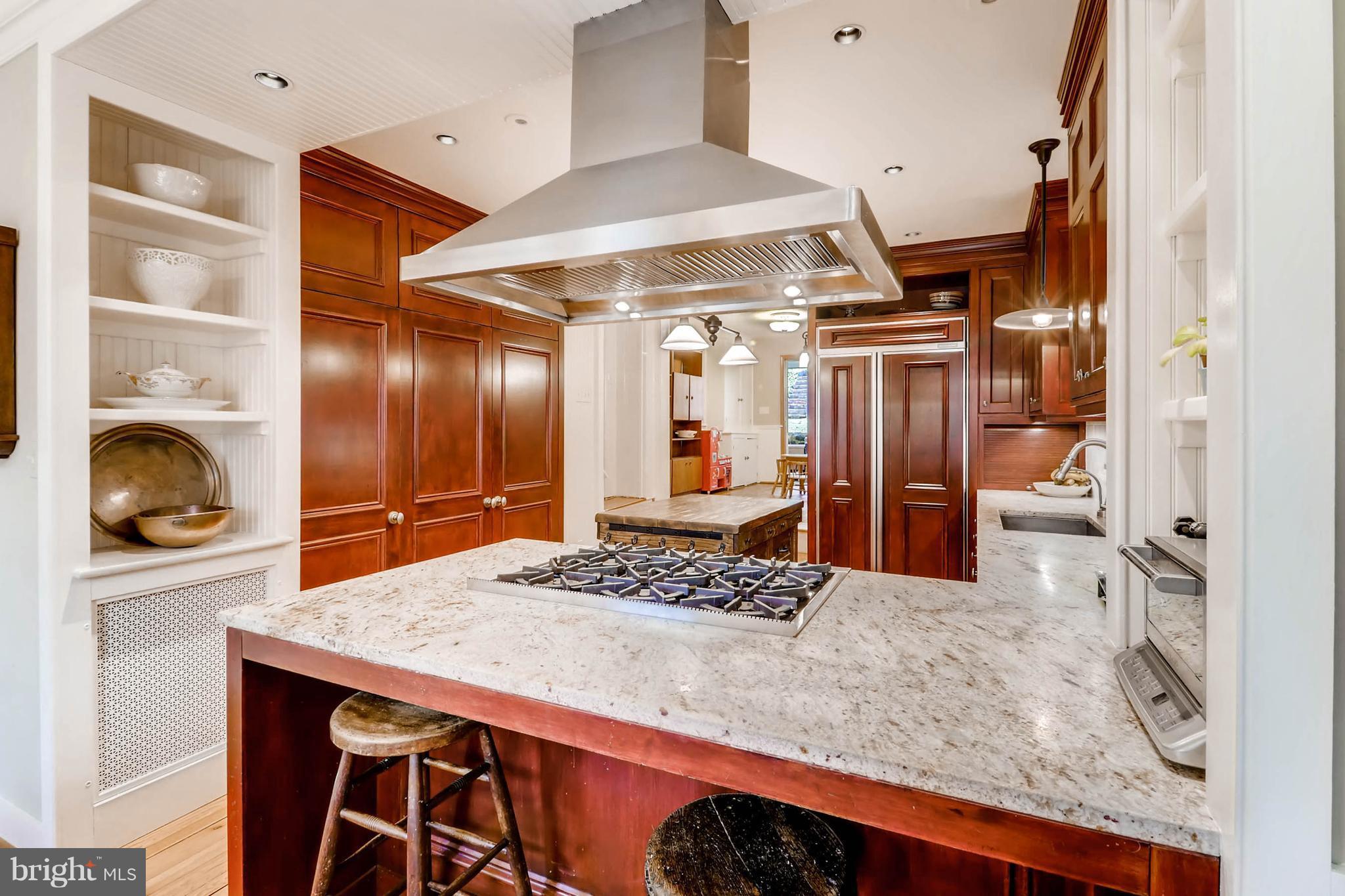 2326 Pickwick Road Baltimore, MD 21207 - Photo 8 of 30 a kitchen with stainless steel appliances granite countertop a sink and a refrigerator