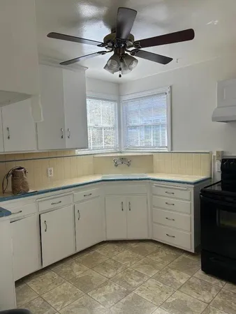 a kitchen with cabinets stainless steel appliances and a window
