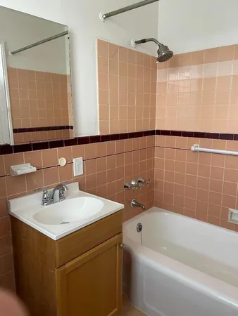 a bathroom with a bathtub a sink and a mirror