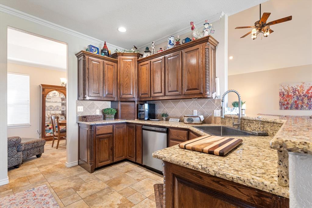 2885 Enloe Road Howe, TX 75459 - Photo 4 of 39 a kitchen with kitchen island granite countertop a sink cabinets and stainless steel appliances