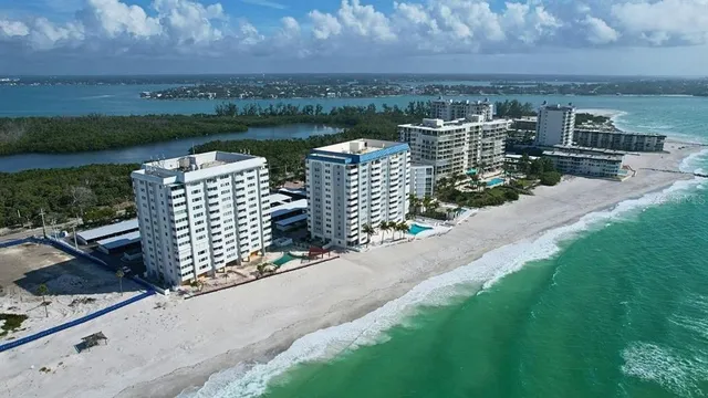 a view of a lake with a bench in front of house
