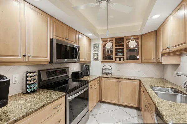 a kitchen with a sink stove and microwave
