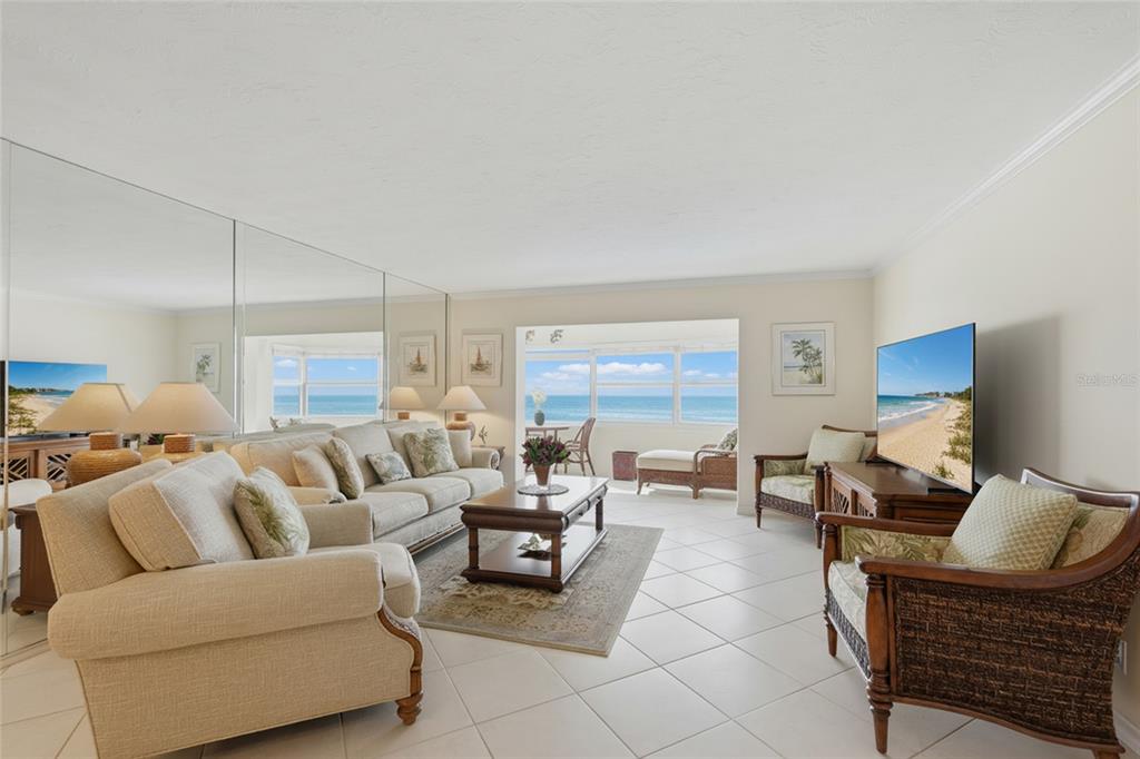 1750 Benjamin Franklin Drive, Unit 9B Sarasota, FL 34236 - Photo 14 of 47 a living room with furniture a lamp and a window