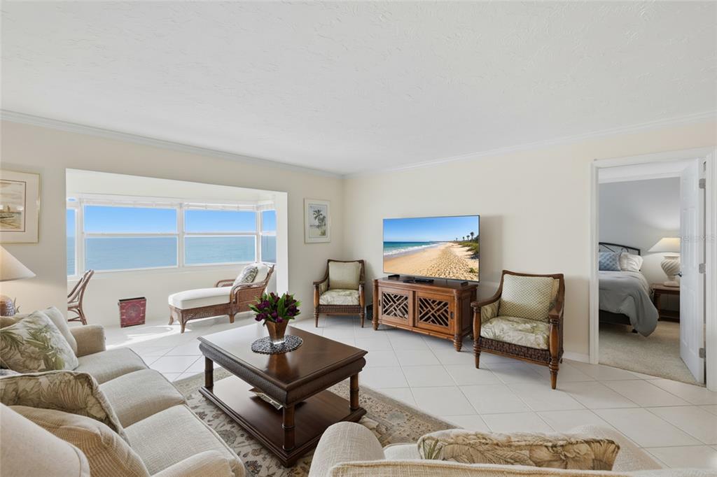 1750 Benjamin Franklin Drive, Unit 9B Sarasota, FL 34236 - Photo 15 of 47 a living room with furniture and a window