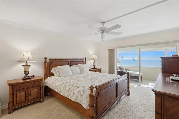 a bedroom with a bed and a tv on the dresser