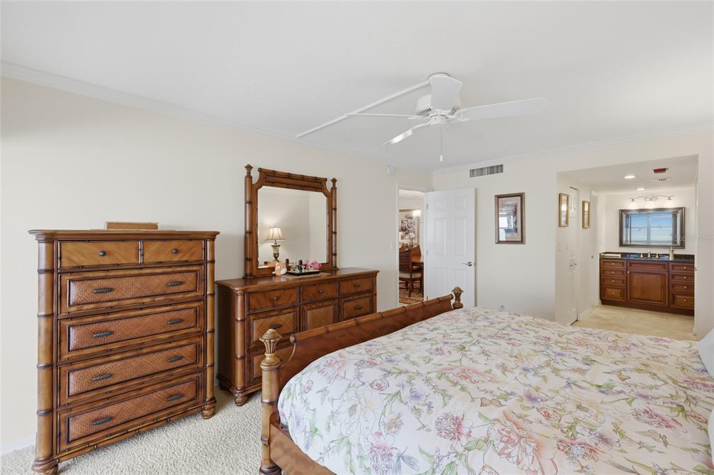 1750 Benjamin Franklin Drive, Unit 9B Sarasota, FL 34236 - Photo 21 of 47 a bed room with a bed and a television