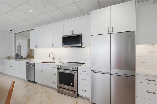a kitchen with a refrigerator stove and sink