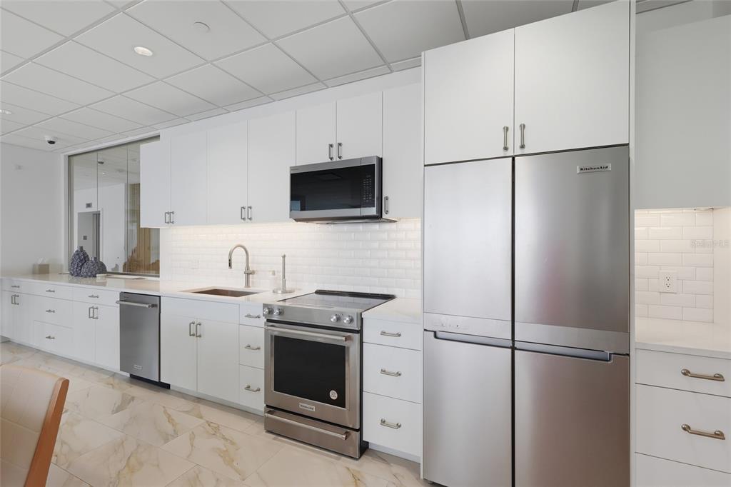 1750 Benjamin Franklin Drive, Unit 9B Sarasota, FL 34236 - Photo 32 of 47 a kitchen with a refrigerator stove and sink