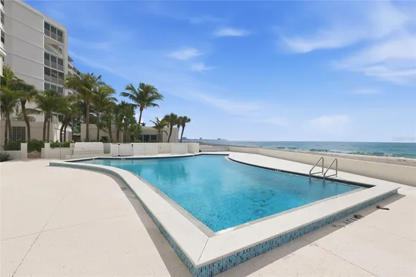 a view of a swimming pool with an outdoor seating