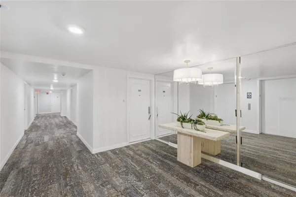 a room with stainless steel appliances kitchen island granite countertop a sink and a stove