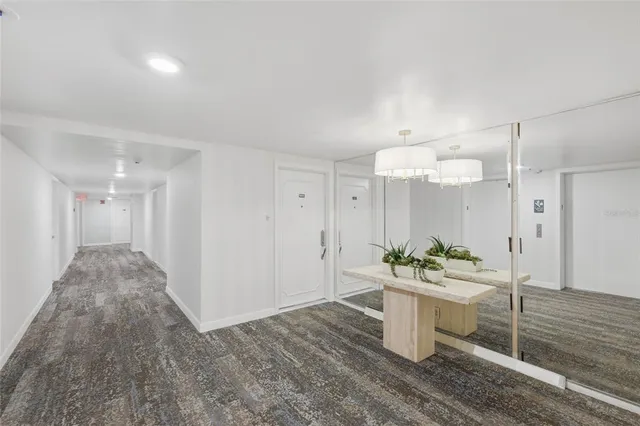 a room with stainless steel appliances kitchen island granite countertop a sink and a stove