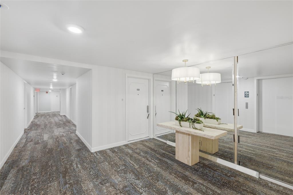 1750 Benjamin Franklin Drive, Unit 9B Sarasota, FL 34236 - Photo 5 of 47 a room with stainless steel appliances kitchen island granite countertop a sink and a stove