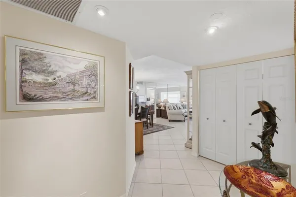 a view of a hallway with workspace and a window