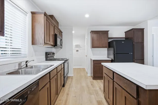 a kitchen with a sink stove and refrigerator