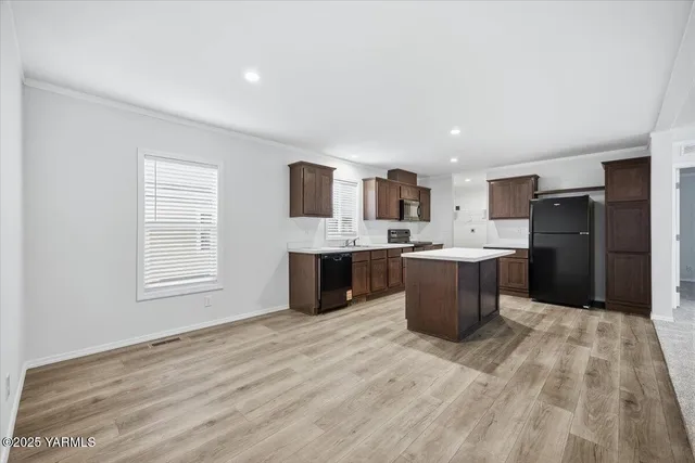a kitchen with a sink a counter top space and stainless steel appliances