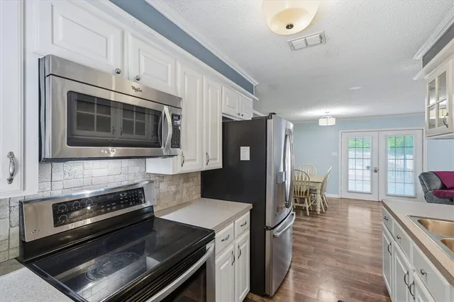 a view of a dining room with furniture and wooden floor