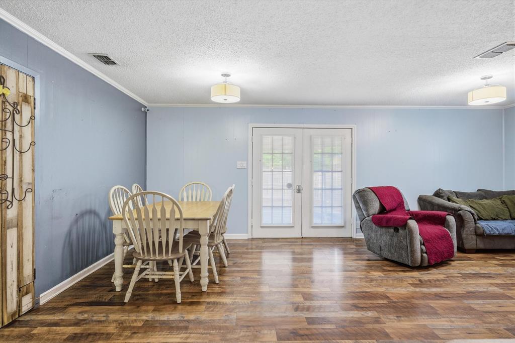 323 Rustic Road Hideaway, TX 75771 - Photo 13 of 40 a view of a dining room with furniture and wooden floor