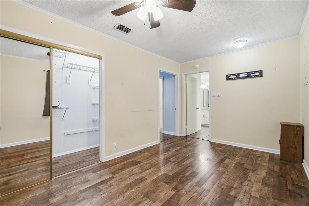 323 Rustic Road Hideaway, TX 75771 - Photo 16 of 40 a view of empty room with wooden floor and fan