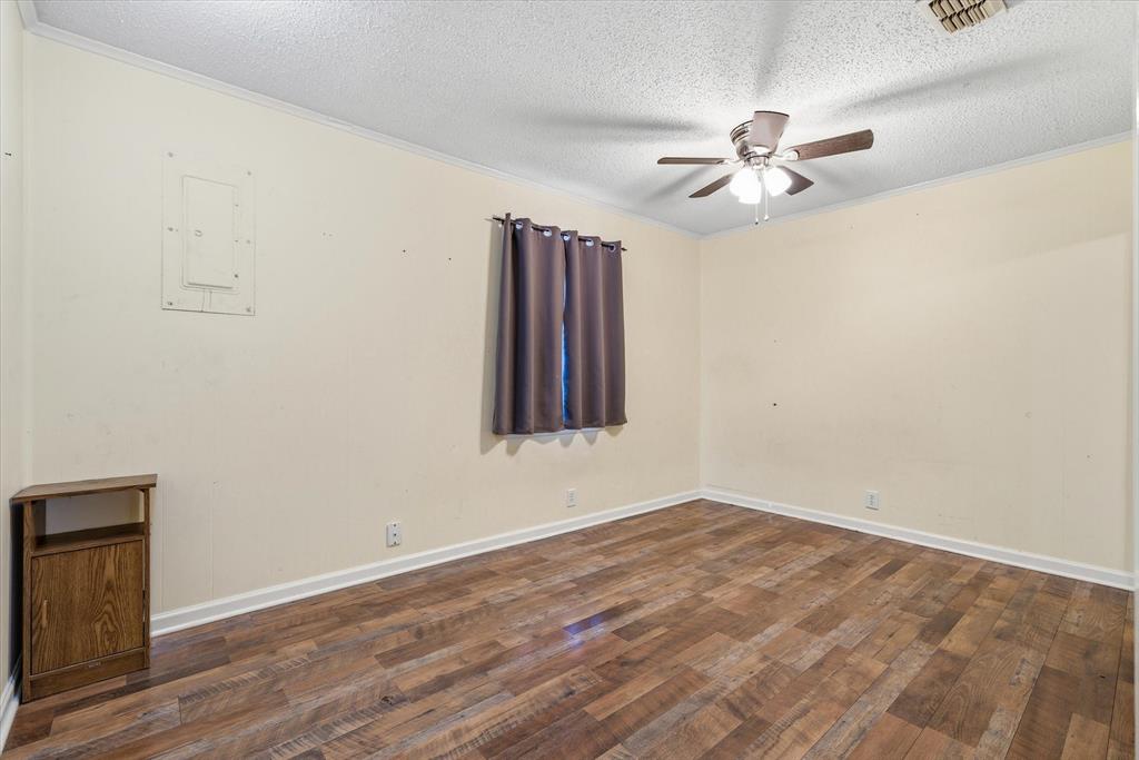 323 Rustic Road Hideaway, TX 75771 - Photo 17 of 40 a view of an empty room with window and wooden floor