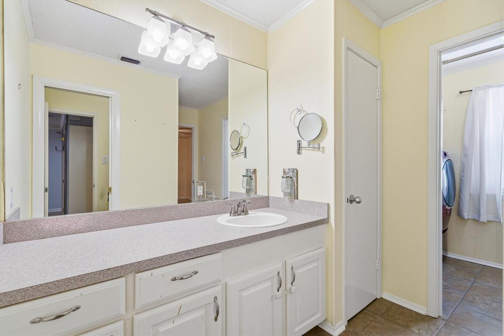323 Rustic Road Hideaway, TX 75771 - Photo 19 of 40 a bathroom with a sink vanity and a mirror