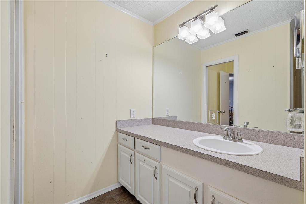 323 Rustic Road Hideaway, TX 75771 - Photo 20 of 40 a bathroom with a sink and a mirror