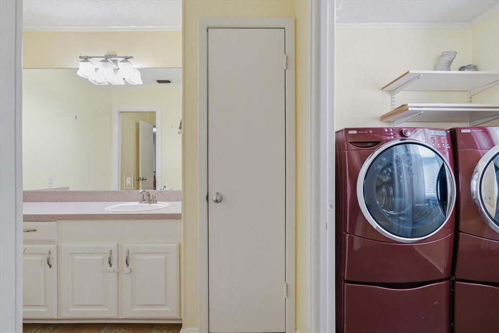 323 Rustic Road Hideaway, TX 75771 - Photo 22 of 40 a bathroom with a sink and a mirror