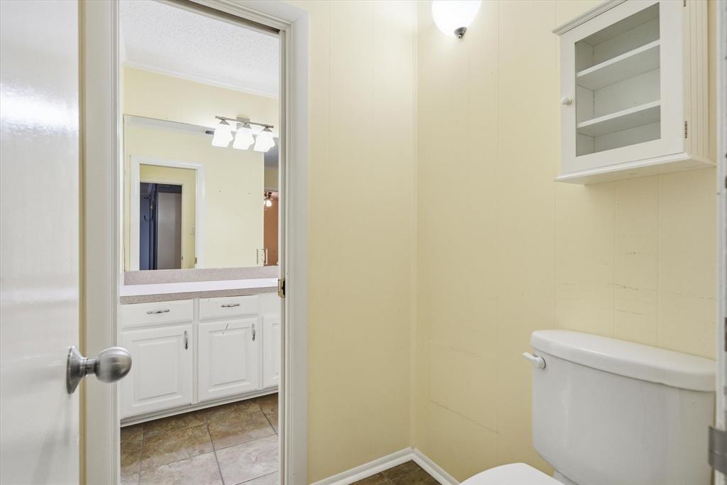 323 Rustic Road Hideaway, TX 75771 - Photo 23 of 40 a bathroom with a sink mirror and toilet
