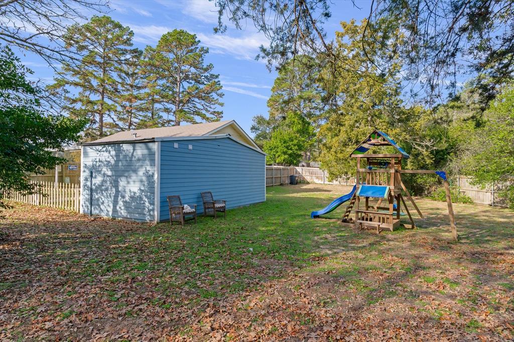 323 Rustic Road Hideaway, TX 75771 - Photo 26 of 40 a view of a backyard with a tree