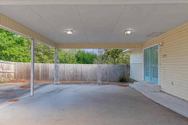 a view of backyard with wooden fence