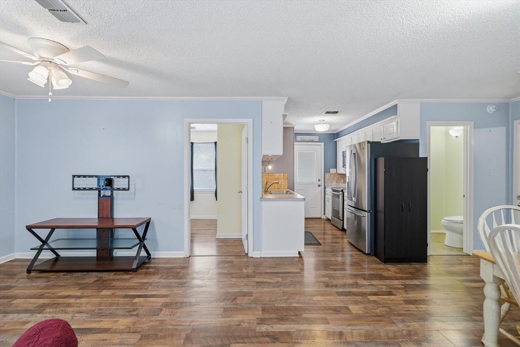 323 Rustic Road Hideaway, TX 75771 - Photo 6 of 40 a view of a kitchen with refrigerator and a stove