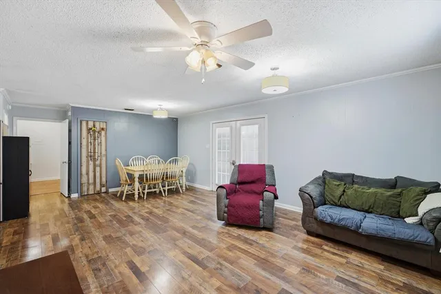 a living room with furniture a dining table and a piano table