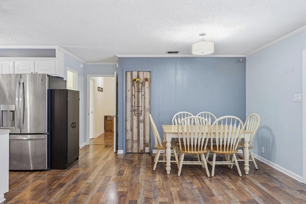 323 Rustic Road Hideaway, TX 75771 - Photo 8 of 40 a view of a dining room with furniture a rug and wooden floor