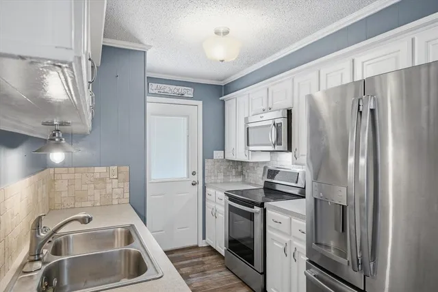 a kitchen with a refrigerator sink and microwave